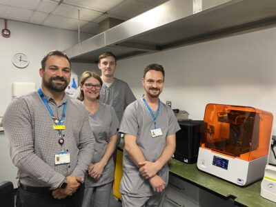 Charity Manager Ben Petts with Orthodontic Technicians Katie O’Dwyer, Tom Apthorpe and Alex Brittain and the new 3D printer