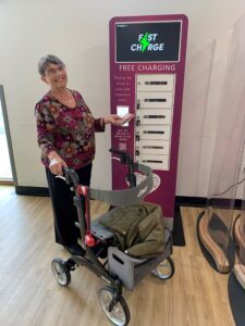 Shirley Churchill using the new phone charge bank at Lincoln County Hospital